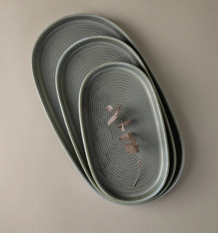 Matte grey ceramic tableware set – textured ribbed plates, bowls and mug, rustic-style home tableware.