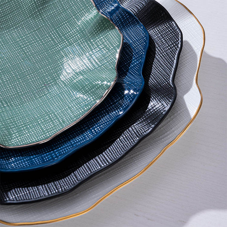 Luxury gold-rimmed bone china tableware set, including ceramic plates and salad bowls, suitable for upscale dining.