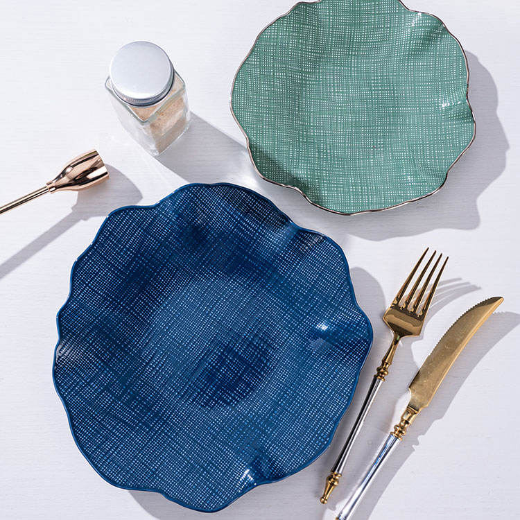 Luxury gold-rimmed bone china tableware set, including ceramic plates and salad bowls, suitable for upscale dining.