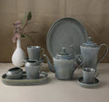 Matte grey ceramic tableware set – textured ribbed plates, bowls and mug, rustic-style home tableware.