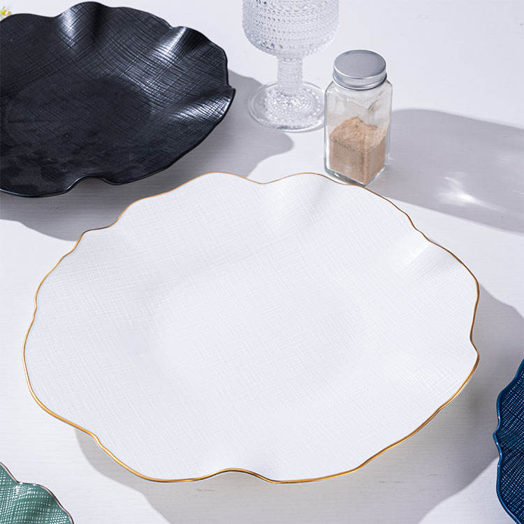 Luxury gold-rimmed bone china tableware set, including ceramic plates and salad bowls, suitable for upscale dining.