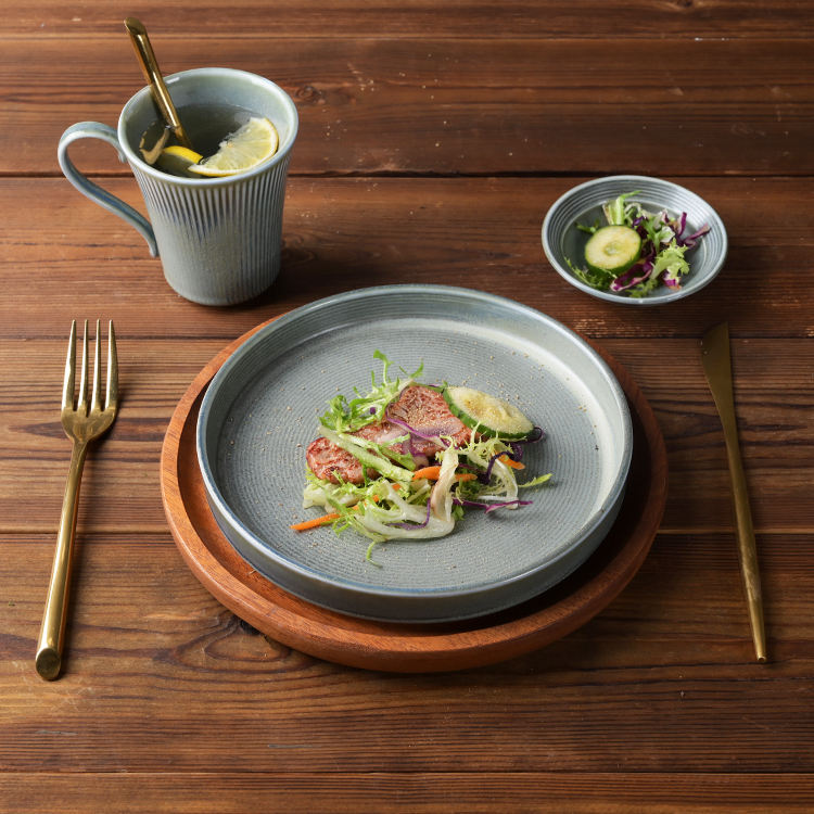 Matte grey ceramic tableware set – textured ribbed plates, bowls and mug, rustic-style home tableware.