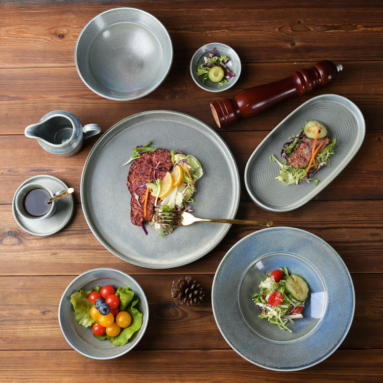 Matte grey ceramic tableware set – textured ribbed plates, bowls and mug, rustic-style home tableware.