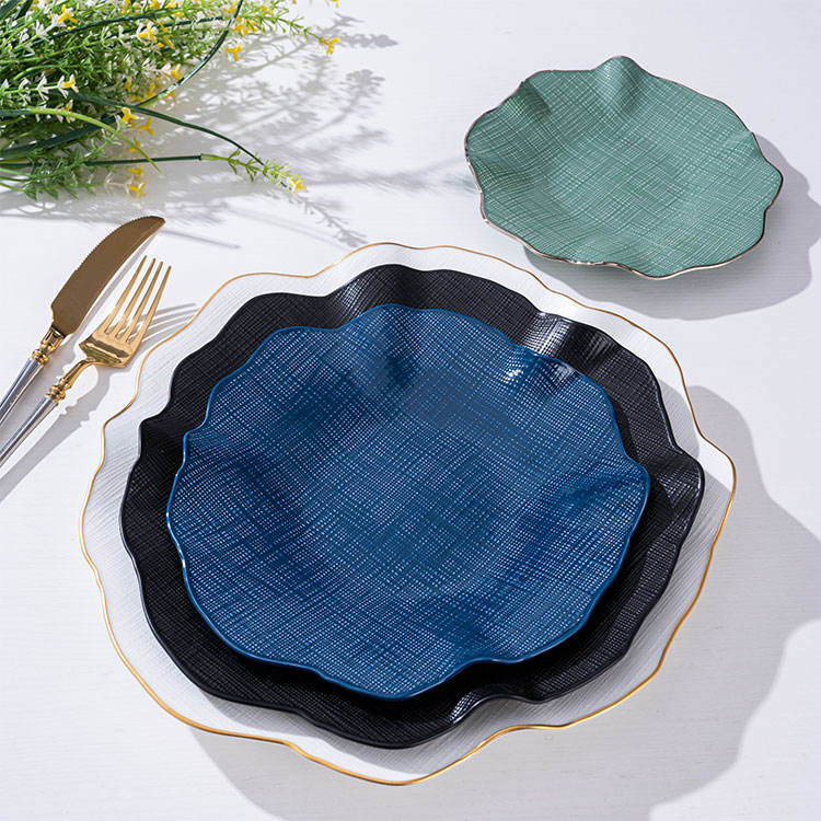Luxury gold-rimmed bone china tableware set, including ceramic plates and salad bowls, suitable for upscale dining.